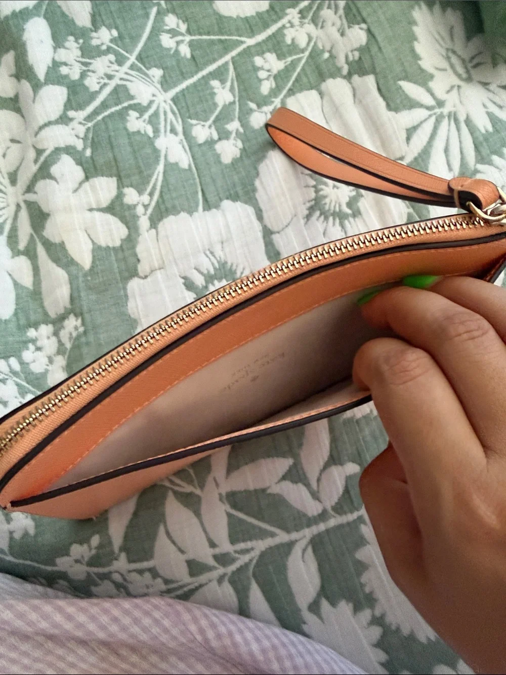 kate spade peach/orange leather wristlet with gold logo